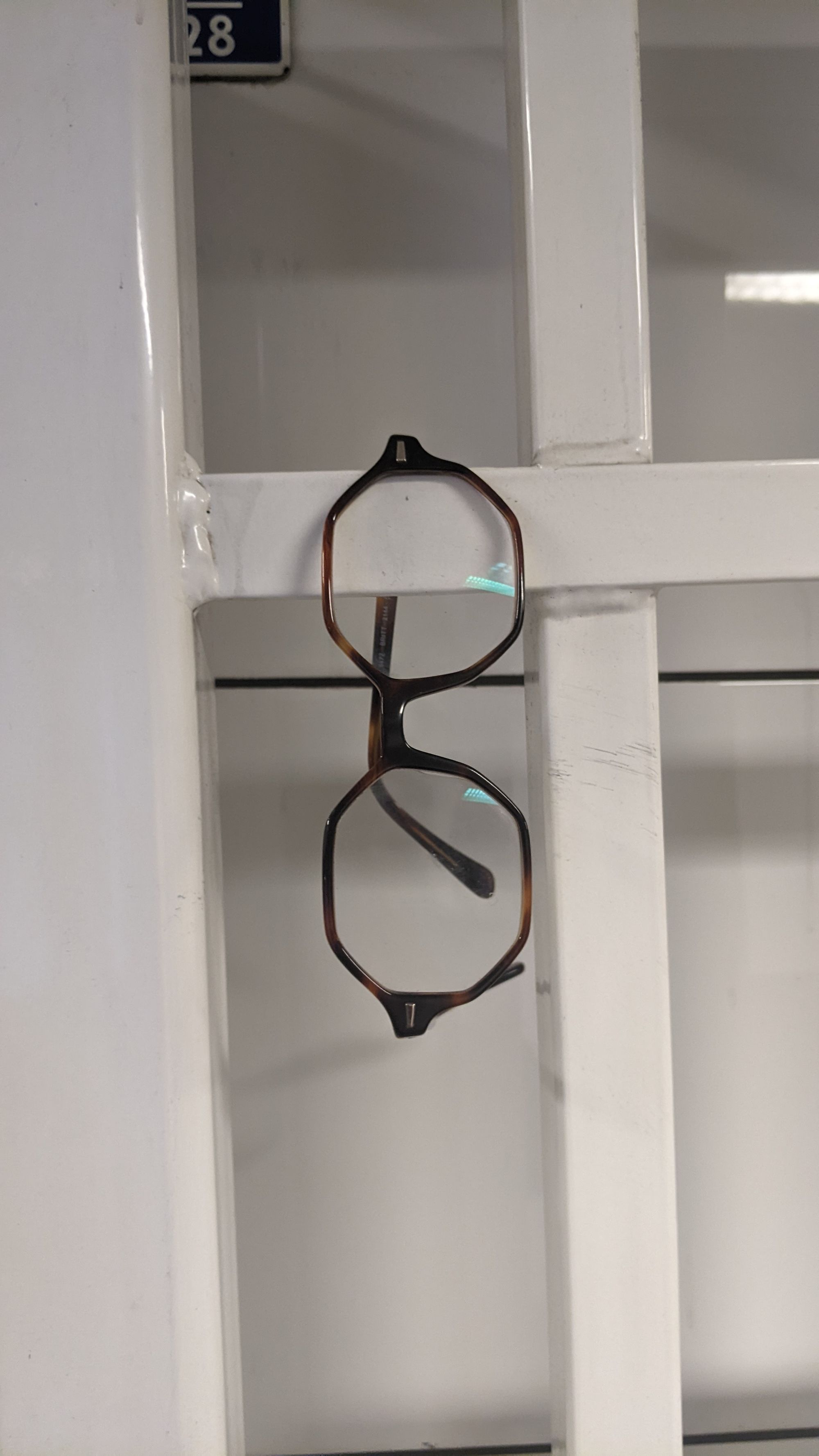 Picture of glasses hanging from a railing