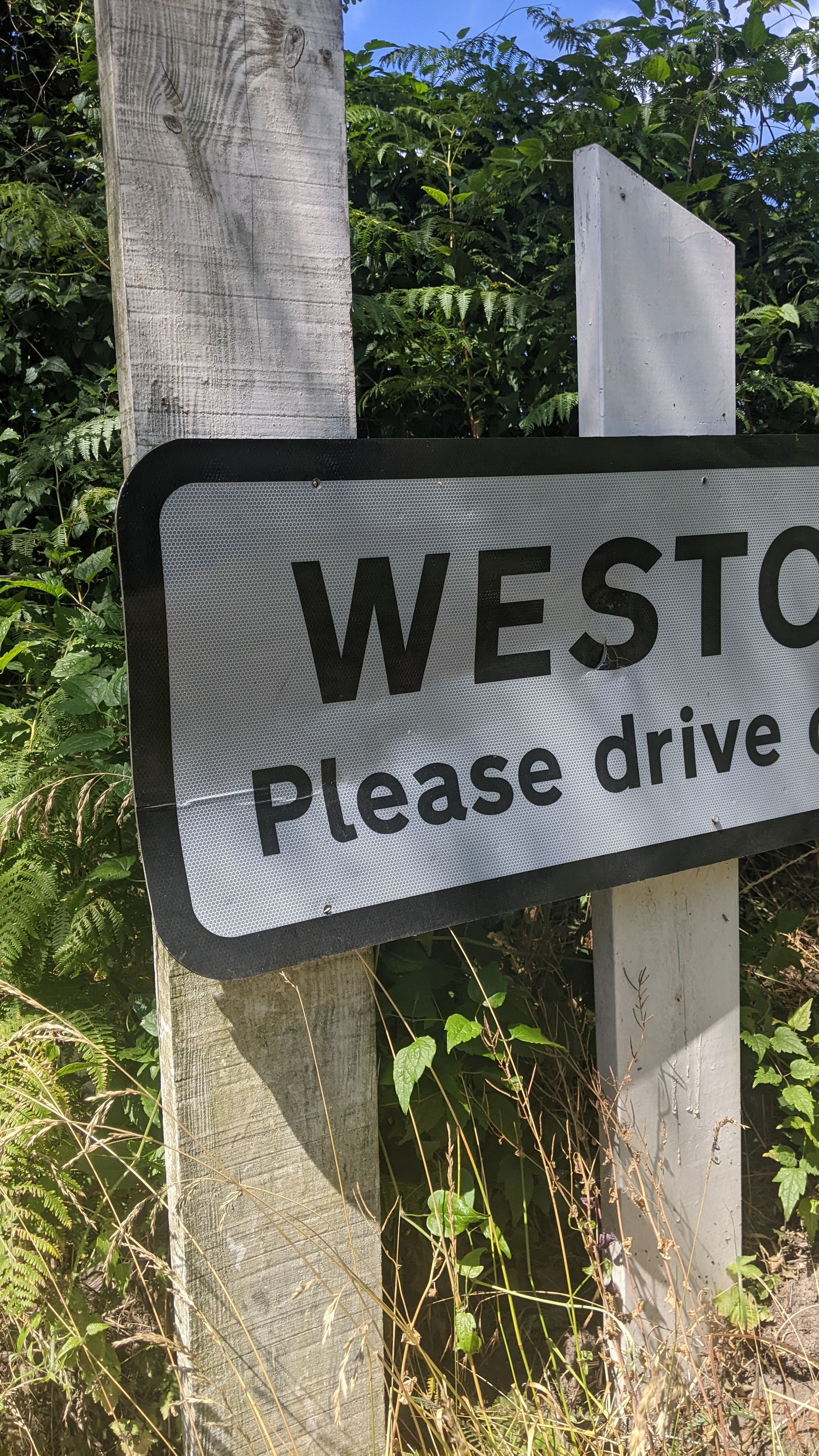 Image of half of a sign. The words read 'Westo, Please drive'