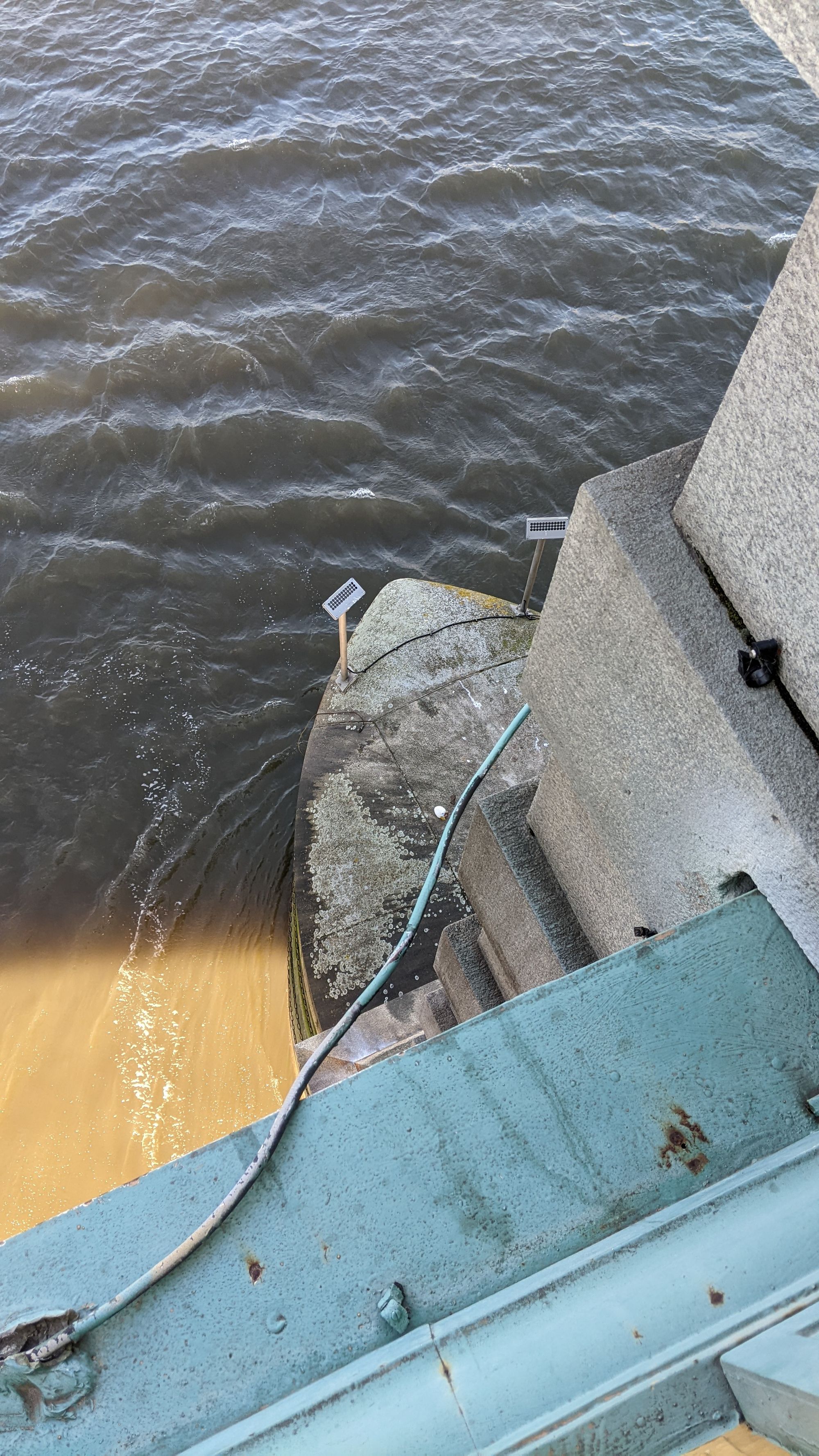 Image of cute plushie egg narrowly avoiding a watery demise, at the base of the bridge